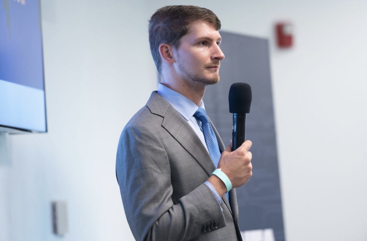 Perry Luzier delivering a keynote with microphone